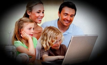A couple with two children and a laptop; based on Shutterstock image 91952378