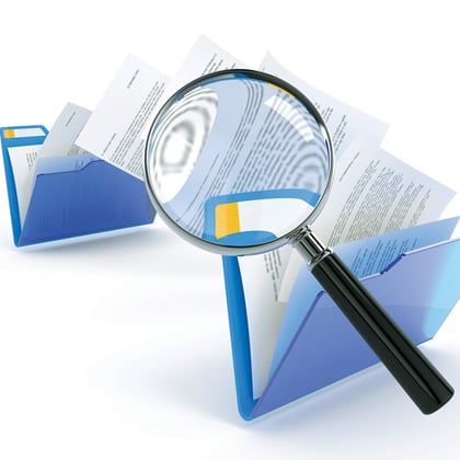 A magnifying glass over folders