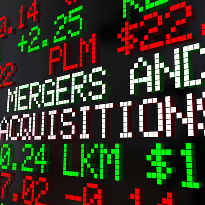 Mergers and Acquisitions written on stock ticker board