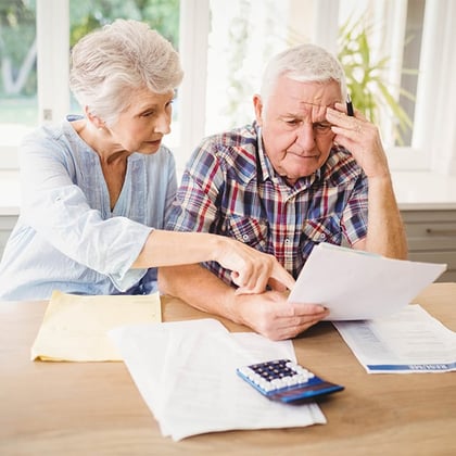 Older couple looking at a bill