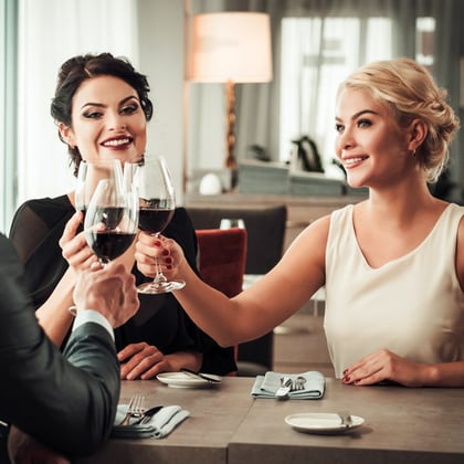 Wealthy people clinking glasses of wine