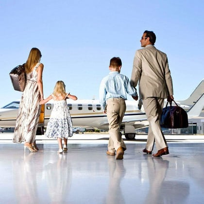 Stock image of wealthy family getting on a private jet.