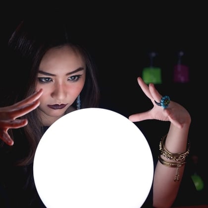 A fortune teller looking into a crystal ball