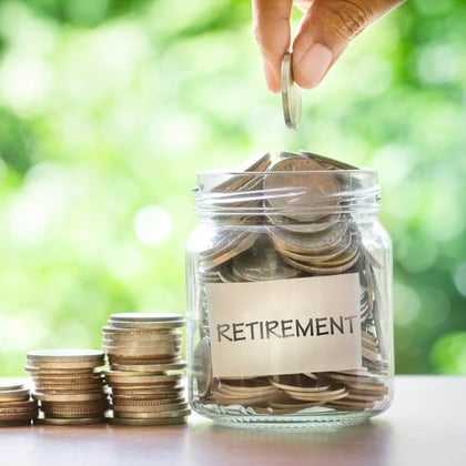 Retirement savings coins in a jar