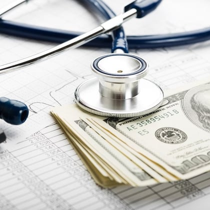 Stethoscope, money and medical bills