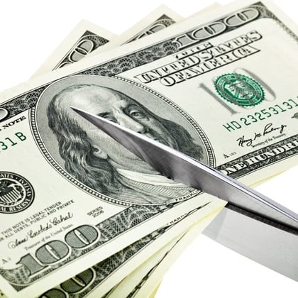 scissors cutting money