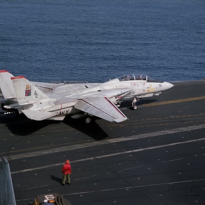 A fighter Squadron II (VF-11) F-14A Tomcat aircraft comes to a stop after landing on the aircraft carrier USS FORRESTAL (CV-59).