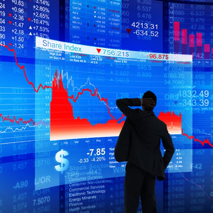 Adobe stock image of a businessman watching a stock chart going down in red