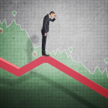 Businessman looking down at a declining stock market; image from Shutterstock