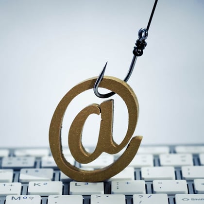A fish hook with email sign on computer keyboard