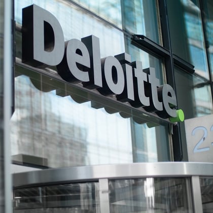 A Deloitte sign over an office building door