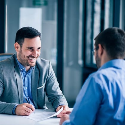 An advisor smiling cheerfully at a client