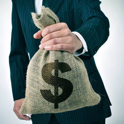 Businessman holding a burlap money bag