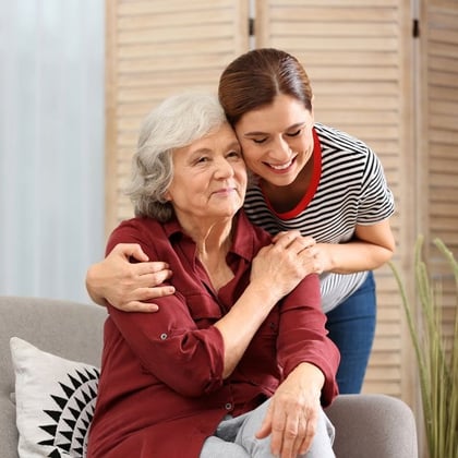 Elderly woman with female caregiver