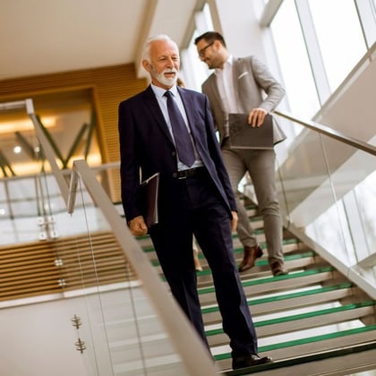 Businessman coming down the stairs in office