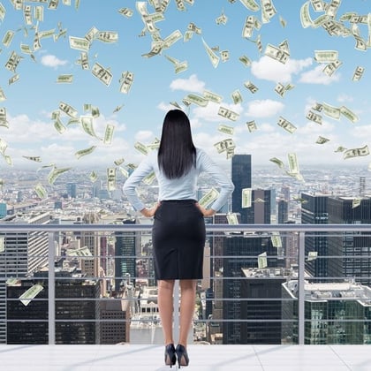 Wealthy businesswoman on a balcony with money falling from the sky