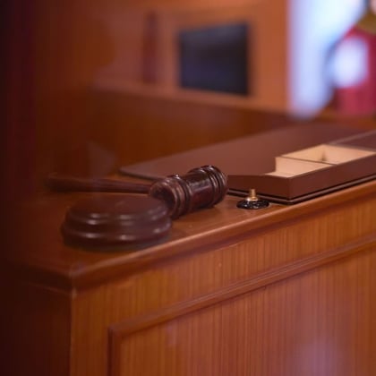 A gavel on a judge's bench in a courtroom