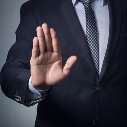 Businessman holding up hand (stop)