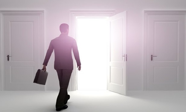 A man walking through a glowing door